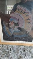 Framed print showing Native American man in full headdress, artwork signed by A. Blackowl, with visible signature and colors.