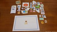 Collection of Queen Elizabeth II stamps, pins, stickers, and an official envelope laid out for overview.