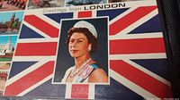 Postcard of Queen Elizabeth in front of Union Jack with text 'Greetings from London'
