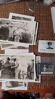 Collection of vintage royal family photographs and postcards laid out on a surface showing various figures and scenes.