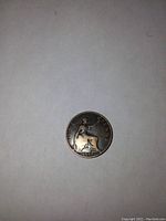 Reverse side of the 1899 one penny coin showing seated Britannia with trident and shield, date clearly visible.