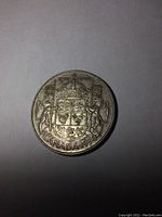 Obverse side showing the Canadian coat of arms, denomination, and year.