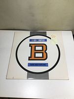 Front cover of the Bad Company Fame and Fortune vinyl LP album showing the cover art with large 'B' and band and album names.