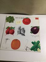 Front cover of the Best of Cream album showing colorful vegetable illustrations and title text.