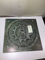 Front cover of the album showing the BTO logo with gear emblem and star, with minor cover wear visible.