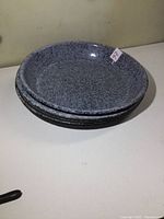 Stack of five enamelware pie plates showing size and rounded edges