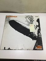 Front cover of Led Zeppelin album featuring black and white image of Hindenburg disaster with Atlantic Records logo and band name.