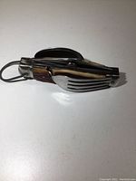 Top view of pocket cutlery folded with visible fork tines and spoon bowl