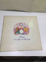 Front cover of the Queen 'A Night at the Opera' vinyl LP sleeve showing crest and album title with signs of wear.