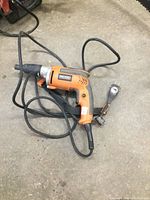 Full view of the Ridgid electric drywall screwdriver showing the orange body, black handle and attached power cord.
