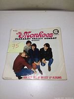 Front of vintage The Monkees 45 rpm single sleeve with picture of band members and song titles.