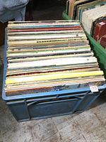 Photo of the milk crate filled with over 60 vintage LP albums mostly country genre, showing the quantity and condition of spines and covers.
