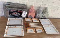 Overview of sushi serving ware including 5 rectangular plates, 4 square sauce dishes, 9 chopsticks, 3 mini wood serving sets in different colors and original sushi serve ware box.