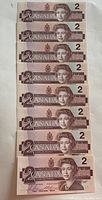 Front of eight sequential 1986 Canadian $2 dollar bills showing Queen Elizabeth II.