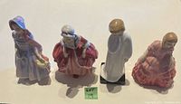 Four Royal Doulton figurines shown side-by-side, depicting characters featuring dresses in pastel colors and varied poses.