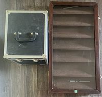 Wood and glass display case and heavy duty storage box side by side on floor