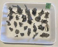 Full lot of 24 metal miniature figures including animals and figures on a white foam base.
