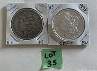 Two USA Morgan one dollar coins dated 1884 and 1893 in holders, obverse side showing Lady Liberty profile