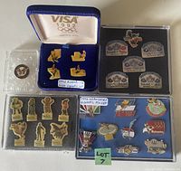 Image showing four sets of pins including the 1992 Albertville Olympic VISA set in box, Los Angeles Olympic pins, Wayne Gretzky Brantford pins and others in cases.