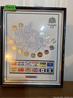 Full view of framed collection showing map, coins, and stamps with Canada 125 title and crest