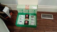 Full boxed Illy espresso set with cups, saucers, and coffee tins inside original packaging.