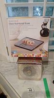 View of both the Hanson Diet Scale Model 1440 and the box for the Salter Glass Nutritional Scale.
