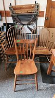 View of the three antique chairs arranged with two bow backs and one lath back in front.