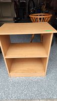 Front view of the wooden office shelf/bookcase showing two open shelves, light wood finish, and rectangular shape.