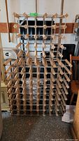 Full view of stacked two-piece wooden wine rack with diamond-shaped slots for holding wine bottles horizontally.