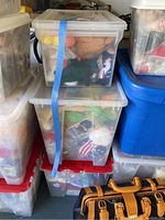 Multiple clear plastic storage bins filled with individually bagged Ty Beanie Babies