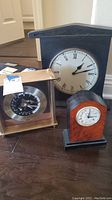 Overview of three mantle clocks showing size and style variety