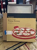 World Market pizza stone packaging showing product branding and pizza illustration.