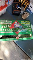Full box view of Bachmann Big Hauler train set in original packaging shown with other items in surrounding area.