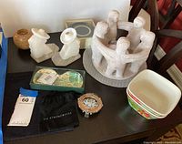 Overview of entire lot showing sculpture, bird bookends, dishes, black cloth, decorative frame and floral dishes.