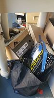 Photo showing boxes including one labeled Rockport size 11 and a black bag labeled Capezio