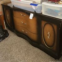 Front view of wooden dresser with three drawers in the middle and two cabinet doors on the sides, featuring gradient wood finish and metal handles.