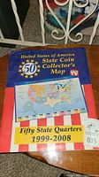 Photo of 50 State Coin Collector's Map with colorful US map and red, white and blue background