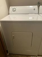 Full front view of the white Whirlpool dryer showing the front door and top control panel.