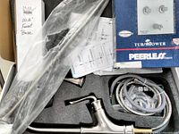 Sanitary Wares kitchen faucet parts including faucet base, ergonomic lever handle, supply hoses, and installation instructions inside protective packaging foam.