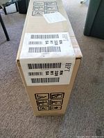 Box labeled with Hotpoint RN328HSA model details and product handling icons.