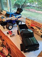 Various toy trucks and cars including Tonka monster truck and Radio Shack remote controlled Lamborghini with box and manual
