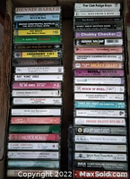 Photo of boxes packed with various audio cassette tapes showing artist labels and genres