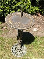 Full view of sundial and pedestal on grass