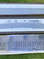 Three panoramic RCMP photographs laid on grass, two framed and one unframed