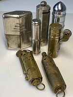 All seven lighters arranged on white background showing shapes and finishes