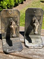 Both bookends side by side on wooden surface, sunlight