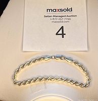 Full view of silver rope chain bracelet measuring approximately 7.5 inches