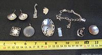 Overview photo of all sterling silver jewelry items arranged with measuring tape for scale.