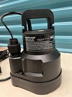 Mastercraft submersible utility pump showing front and side views, including label with caution and operation warnings.