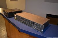Photo showing Yamaha stereo power amplifier and Rane graphic equalizer placed on a blue countertop, viewed from an angle